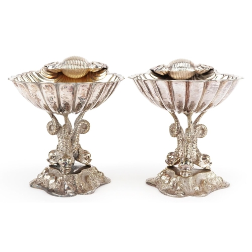 1358 - A pair of late 19th century plated bonbon dishes, the half shell bowl raised on three dolphin suppor... 