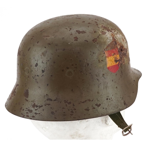 2595 - A Spanish military interest tin helmet with decals and liner.