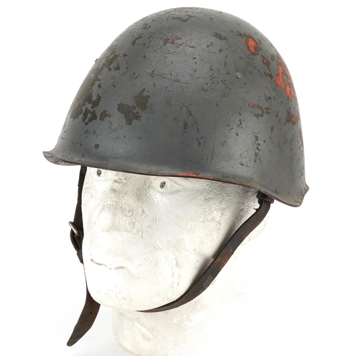 2593 - A military interest tin helmet with liner.