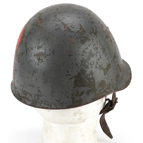 2593 - A military interest tin helmet with liner.