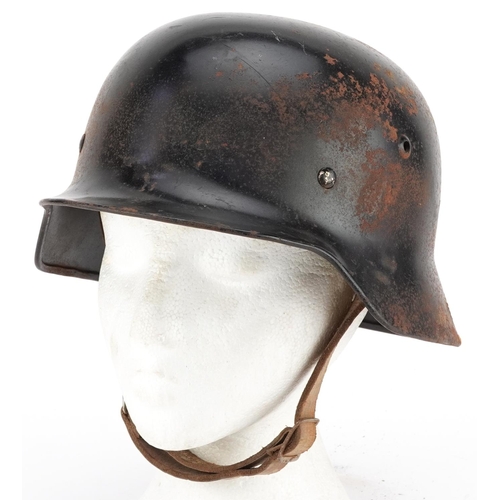 2597 - A German military interest tin helmet with liner.