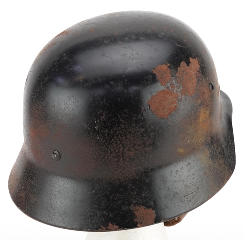 2597 - A German military interest tin helmet with liner.