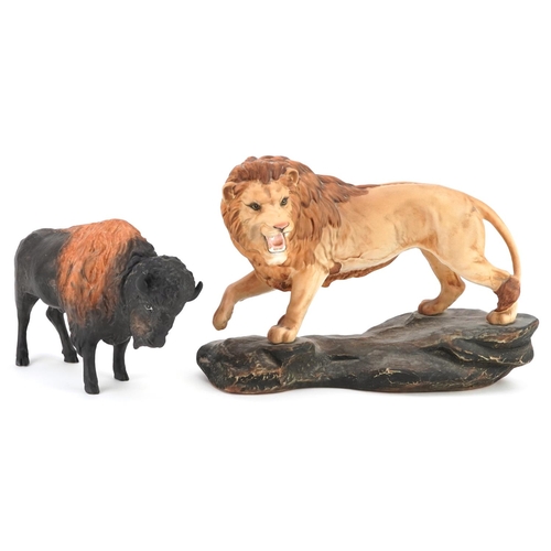 1215 - A large Beswick matt glaze lion on a rock and a Coalport matt glaze bison, the largest 31cm in lengt... 