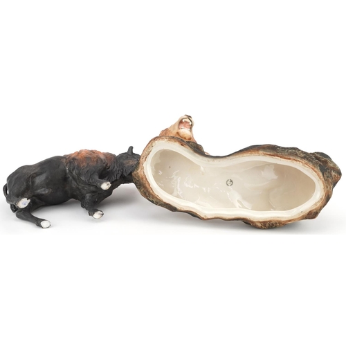 1215 - A large Beswick matt glaze lion on a rock and a Coalport matt glaze bison, the largest 31cm in lengt... 