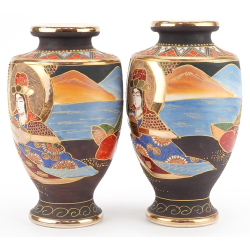 1368 - A pair of Japanese Satsuma pottery vases hand painted with figures. 26cm high