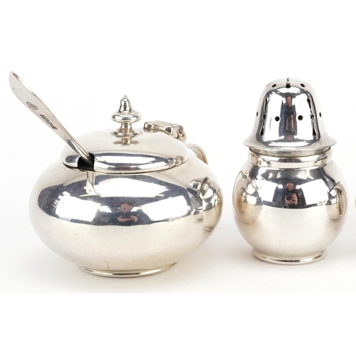 430 - Ackroyd Rhodes, an Arts & Crafts silver four piece cruet with spoons and blue glass liners, London 1... 