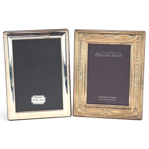 591 - Carrs, two rectangular silver easel photo frames with boxes, one having embossed decoration, with bo... 