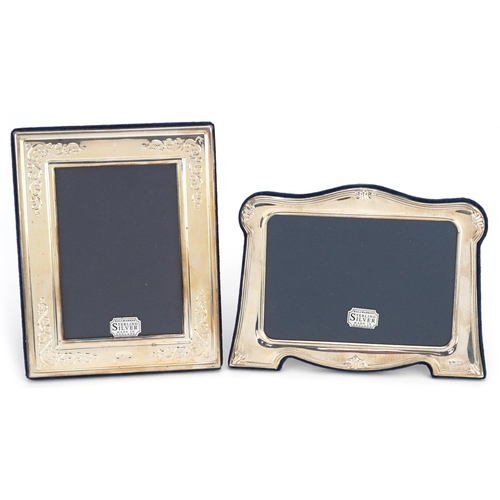 592 - Carrs, two rectangular embossed silver easel photo frames with boxes, Sheffield 1995 and 1997, the l... 