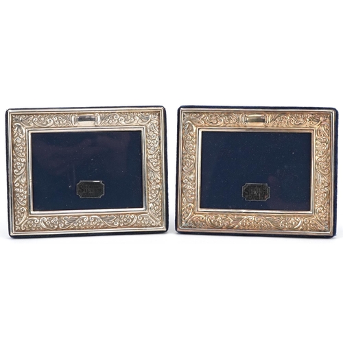 600 - Carrs, pair of rectangular embossed silver easel photo frames, Sheffield 1994, 13cm x 10cm.