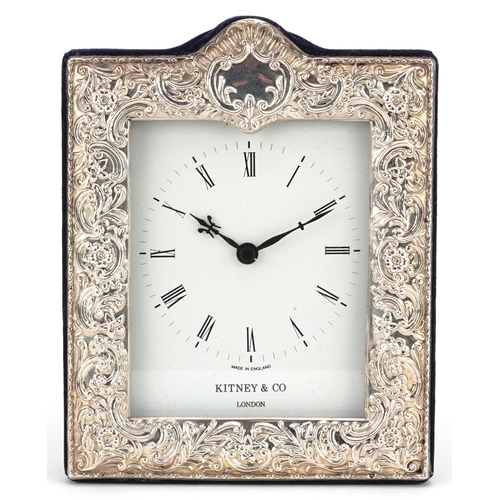 570 - Kitney & Co, silver easel clock profusely embossed with flowers and foliage with box, London 1995, 1... 