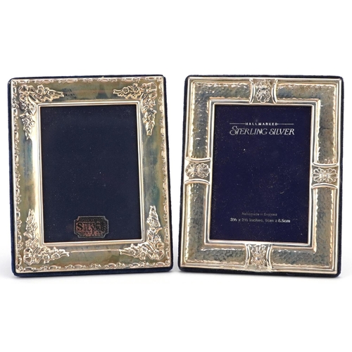 597 - Carrs, two rectangular embossed silver easel photo frames with boxes, Sheffield 1989 and 1994, 13cm ... 