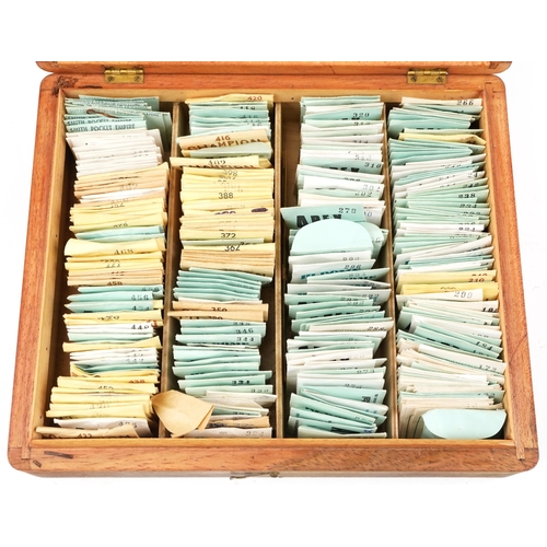 3342 - A collection of wristwatch glasses, variously sized, within a wooden box, 30cm wide.