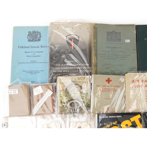 2526 - Militaria including black and white photographs, First Aid in Wartime, World War II bibles, First Ai... 