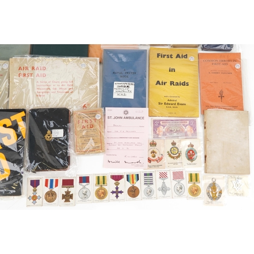 2526 - Militaria including black and white photographs, First Aid in Wartime, World War II bibles, First Ai... 