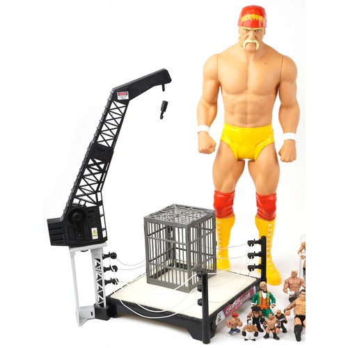 1322 - A collection of vintage World Wrestling action figures and accessories together with two crash cages... 