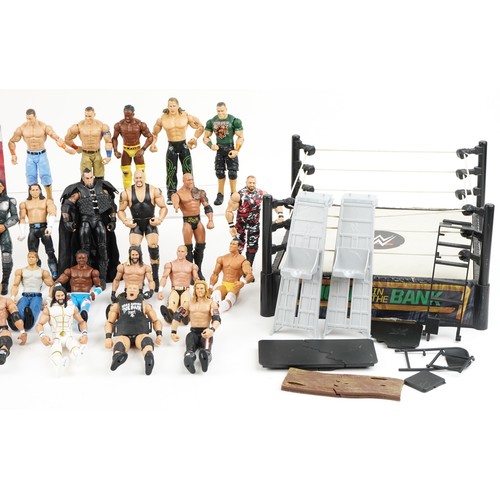 1322 - A collection of vintage World Wrestling action figures and accessories together with two crash cages... 