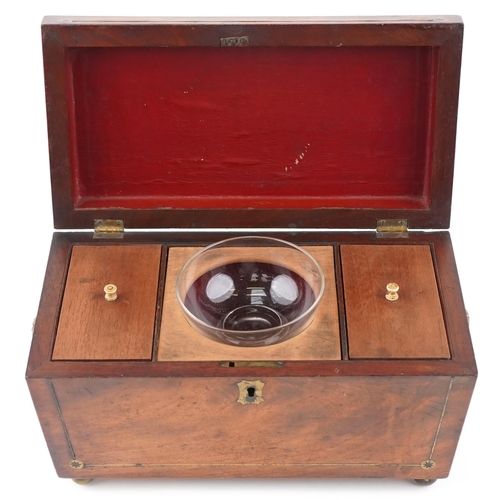 142 - An early 19th century figured mahogany sarcophagus tea caddy with brass inlaid decoration, the hinge... 