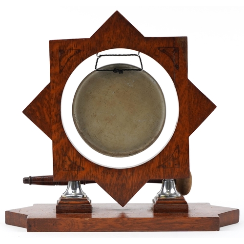 129 - An early 20th century oak framed table dinner gong, 35cm H x 36cm W x 14cm D.