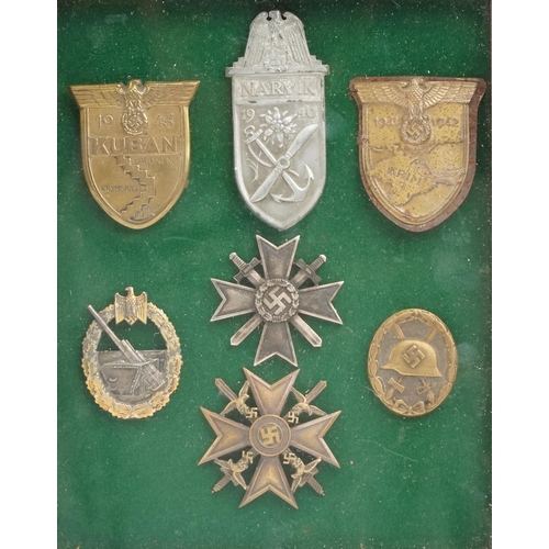 2547 - Seven German military interest cap badges, framed and glazed, 31cm x 25cm.