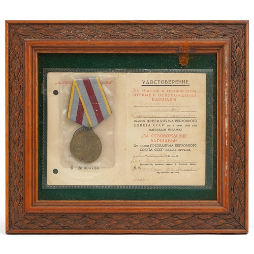 2485 - A Russian military interest medal with ribbon and paperwork, framed and glazed.