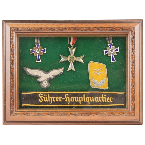 2550 - A group of German military interest medals, cloth patches and armband including two Mother's Crosses... 