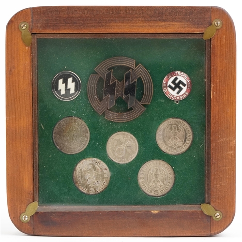 2549 - Three German military interest enamelled badges and five coins, framed and glazed.