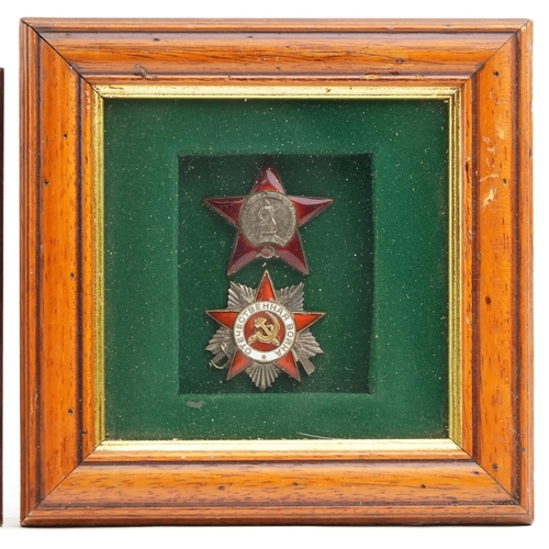 2486 - Two Russian military interest cap badges and a medal, framed and glazed.