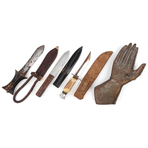 2447 - Three hunting knives with leather sheaths and a cast iron suit of armour glove plaque, the largest 3... 