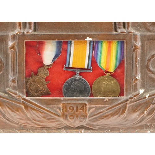  A British military World War I medal trio and death plaque housed in a cast metal and carved oak fra... 