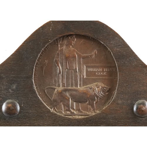  A British military World War I medal trio and death plaque housed in a cast metal and carved oak fra... 