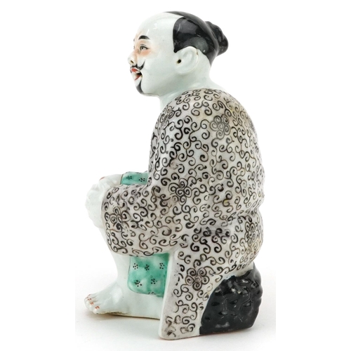 339 - A Chinese porcelain figure of a seated man, 20th century, 19cm high.