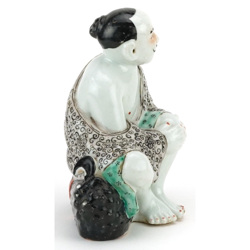 339 - A Chinese porcelain figure of a seated man, 20th century, 19cm high.