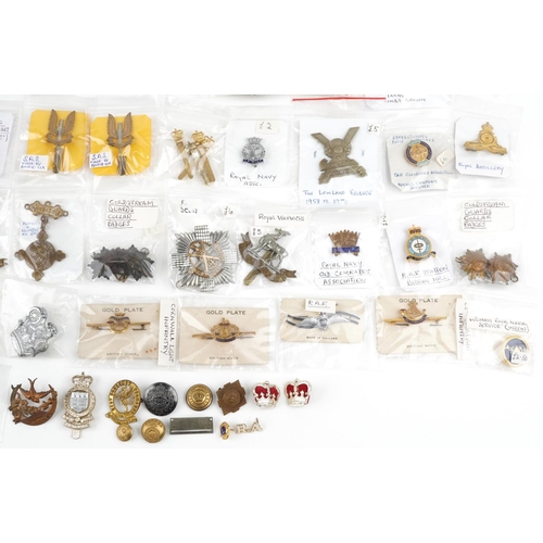 2497 - A collection of military interest cap badges, collar badges and pins including General Service, Roya... 