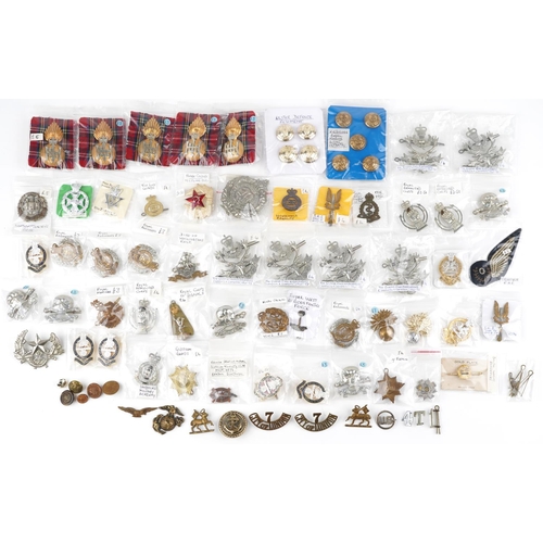 2498 - A collection of military interest cap badges, shoulder titles, uniform buttons and pins including Th... 