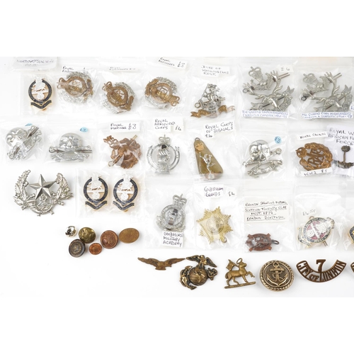 2498 - A collection of military interest cap badges, shoulder titles, uniform buttons and pins including Th... 