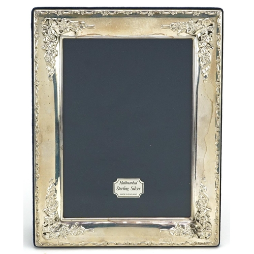 587 - Carrs, rectangular silver easel photo frame embossed with flowers and bows, Sheffield 1997, 22cm x 1... 