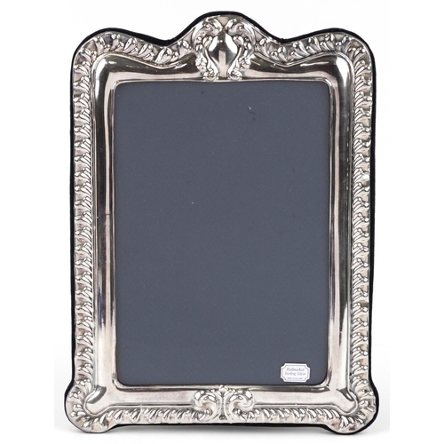 582 - David Richards & Sons, large Victorian style rectangular silver easel photo frame having embossed de... 