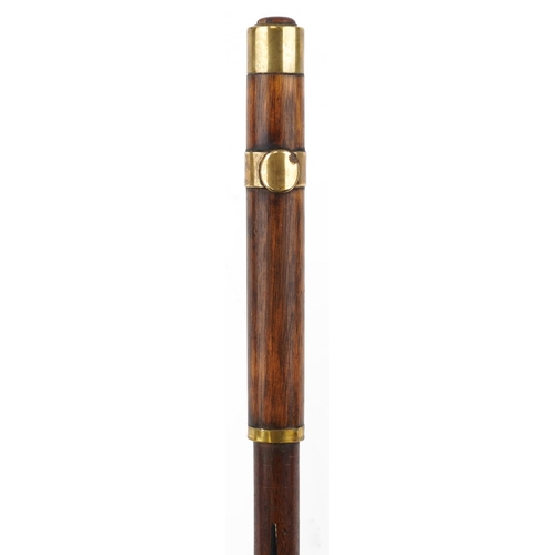 228 - A 19th century mahogany propelling swordstick with brass mounts and ebonised decoration, 90cm in len... 