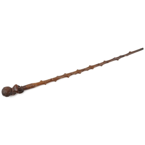 219 - A 19th century knurled wood walking cane carved with a bust of a man, 88cm in length.