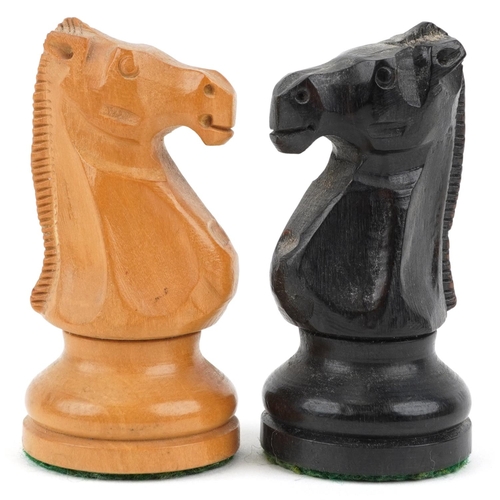 1244 - A boxwood and ebony Staunton pattern chess set with weighted bases housed in a Staunton box, the lar... 