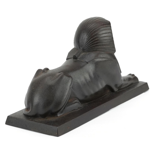 70 - A Hanau cast iron figure of a recumbent Sphinx, early 19th century, The E.G. Zimmermann Foundry, 23c... 