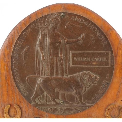 2424 - A British military World War I death plaque awarded to William Carter, mounted on an oak back with h... 