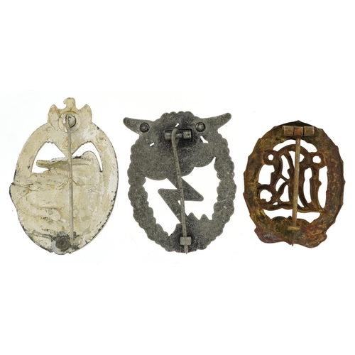 2556 - Three German military interest cap badges.