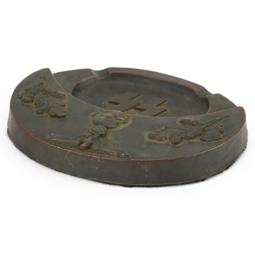 2575 - A German military interest bronzed SS desk stand, 19cm wide.