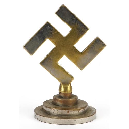 2568 - A German military interest cast metal swastika paperweight, 12cm high.