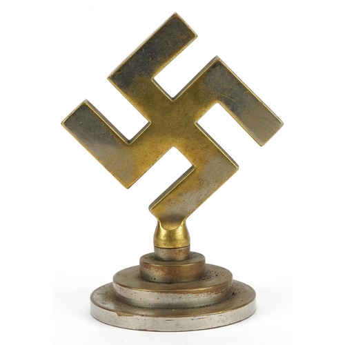 2568 - A German military interest cast metal swastika paperweight, 12cm high.