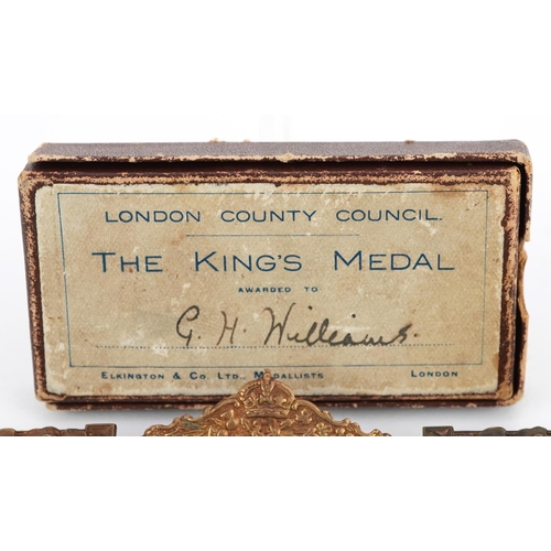 2433 - A collection of commemorative medallions and awards including The King's Medals for Attendance award... 