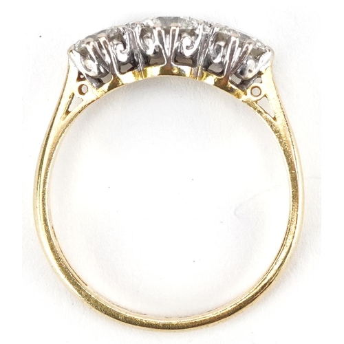 3002 - An 18ct gold diamond three stone ring, total diamond weight approximately 1.45 carat, size U, 4.5g.