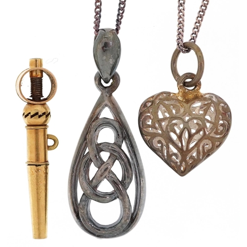 3309 - Two silver pendants on silver necklaces and an antique yellow metal watch key, total weight 7.0g.