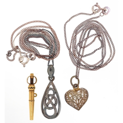 3309 - Two silver pendants on silver necklaces and an antique yellow metal watch key, total weight 7.0g.